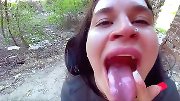 Sucking in public outdoors near people and getting hot sticky cum in her mouth