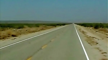 She stands in the dessert and stop a bus - she stand inside the bus and she can´t stop what happens