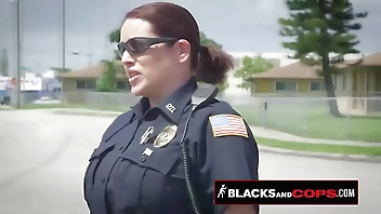 Curvy blonde MILF officer is sitting on a black criminal's big cock in public.